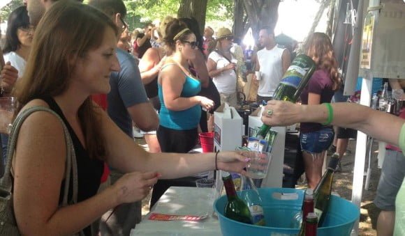Pouring a glass of wine at the Corn Hill Arts Festival Beer and Wine Garden
